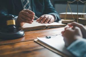 Lawyer offering legal advice on judgments, agreements, and justice to a client.