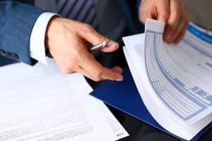 A Lawyer discussing insurance documents, focusing on truck accident claims, during a meeting.