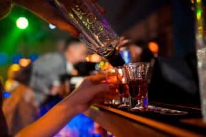 Bartender preparing and serving alcoholic cocktails.